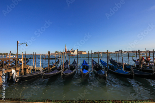 Gondolas on a pier at Grand Canal, Venice, Italy. © Velizar  Gordeev