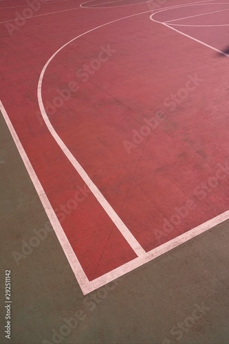 empty red basket court with white lines on the street