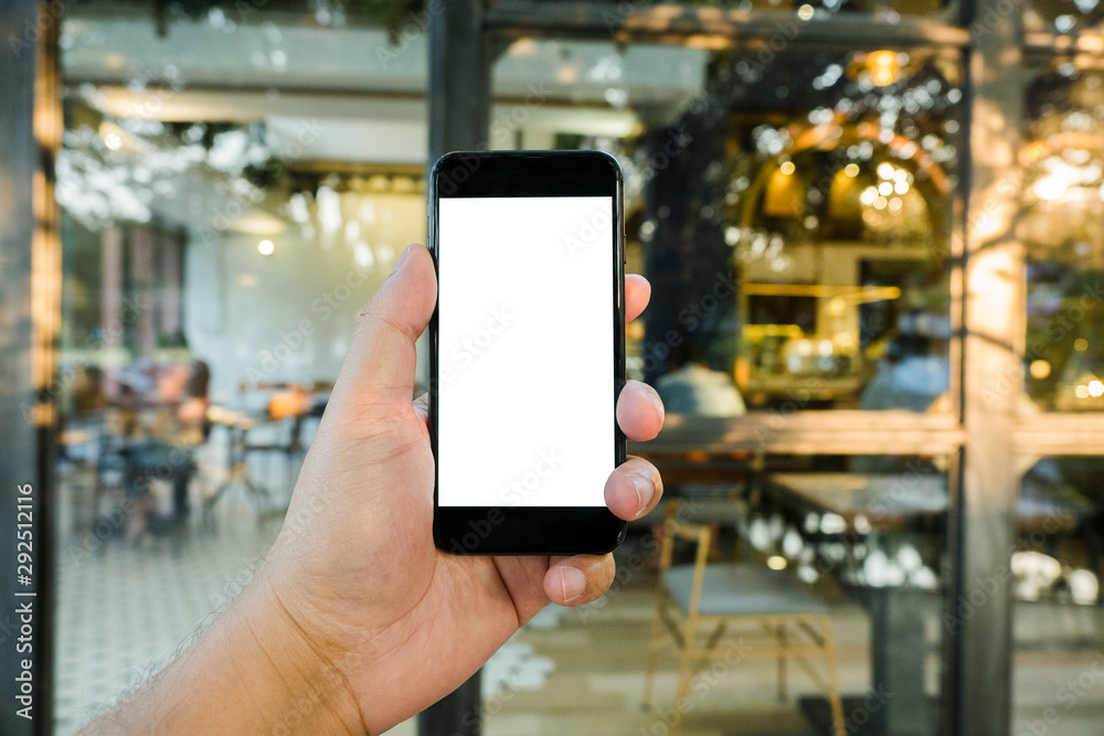 big hand holding blank screen phone on window cafe shop.blurred background big hand holding blank screen phone on window cafe shop.blurred background