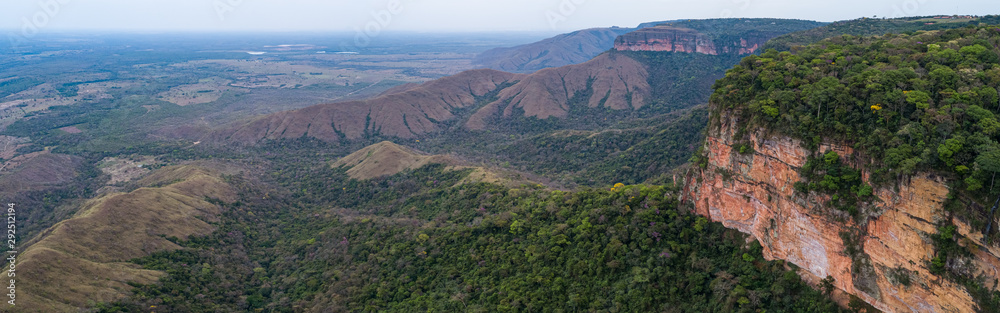 Aerial view of table mountains cliffs with foothills covered with rainforest, Chapada dos Guimarães, Mato Grosso, Brazil, South America