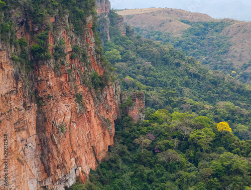 Close up of a cliff edge and view in a valley with rainforest pockets, Chapada dos Guimarães, Mato Grosso, Brazil, South America