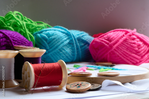 Embroidery accessories for a variety of colors, such as yarn, needle and buttons brought together for workshop class. photo