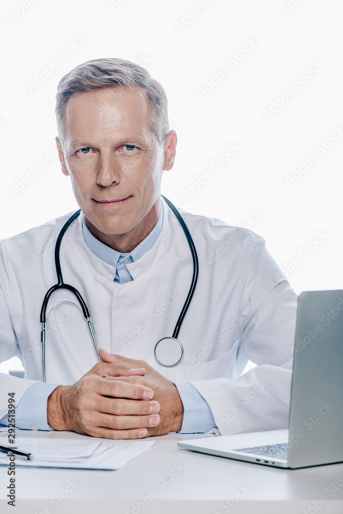 handsome doctor in white coat looking at camera isolated on white handsome doctor in white coat looking at camera isolated on white