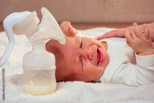 Manual breast pump, mothers breast milk giving healthy food for newborn (hungry baby crying)