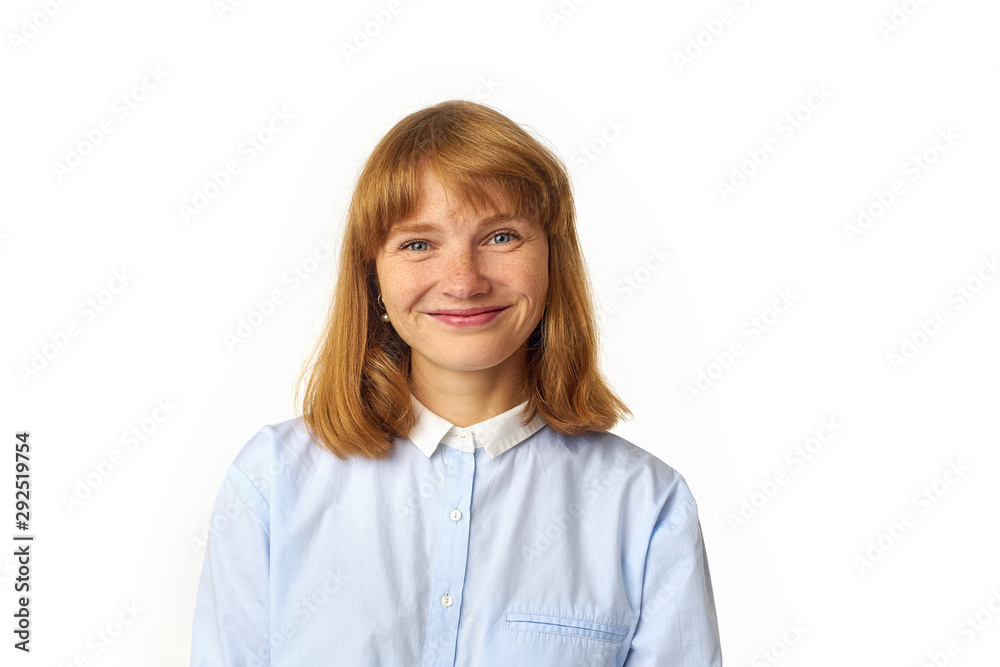 Close up portrait of young beautiful redhead girl in white shirt smiling looking at camera. Copy space. Isolated on white background. Close up portrait of young beautiful redhead girl in white shirt smiling looking at camera. Copy space. Isolated on white background.