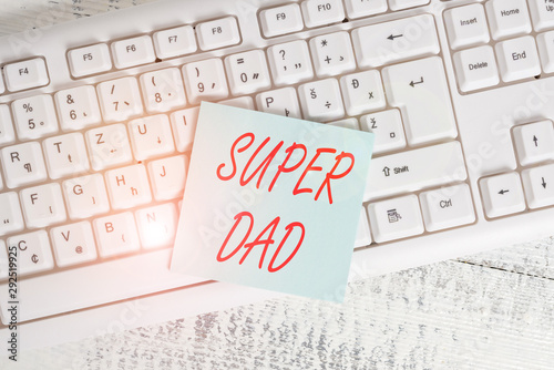 Conceptual hand writing showing Super Dad. Concept meaning Children idol and super hero an inspiration to look upon to Keyboard office supplies rectangle shape paper reminder wood photo