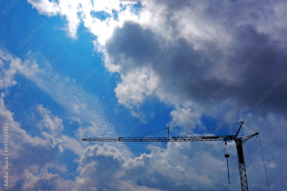 Tower crane in the mountains under storm clouds Tower crane in the mountains under storm clouds