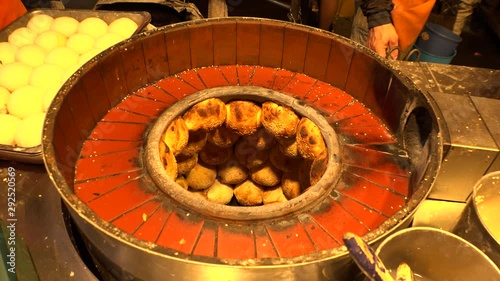 View of cooking Taiwanese popular street food, “Baked Pepper bun” in Taipei. Meat (pork or beef) marinated with sugar, soy sauce, white pepper or black pepper, and scallion for the inside filling. photo