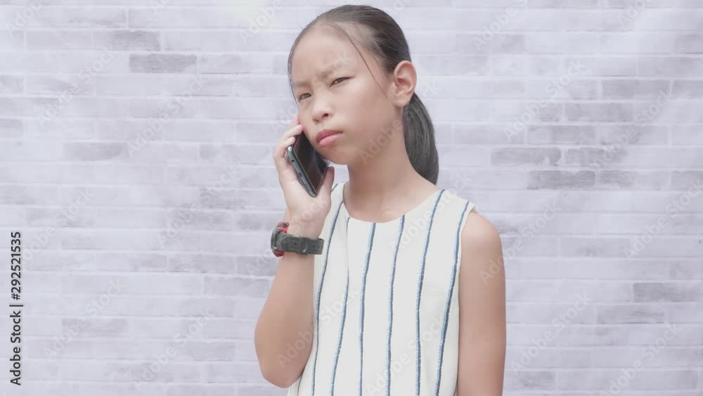 Childhood and technology. Cute asian girl using smart phone. Childhood and technology. Cute asian girl using smart phone.
