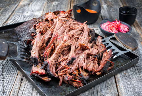 Fotografie Traditional barbecue wagyu pulled beef offered with Carolina BBQ sauce and onion