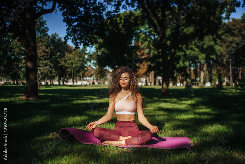 Sports girl doing yoga in the park