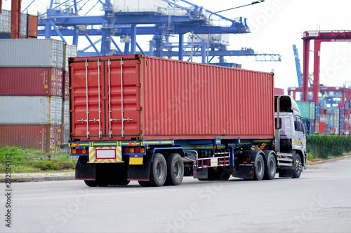 Truck on road with red container, transportation concept.,import,export logistic industrial Transporting Land transport on Port transportation storge