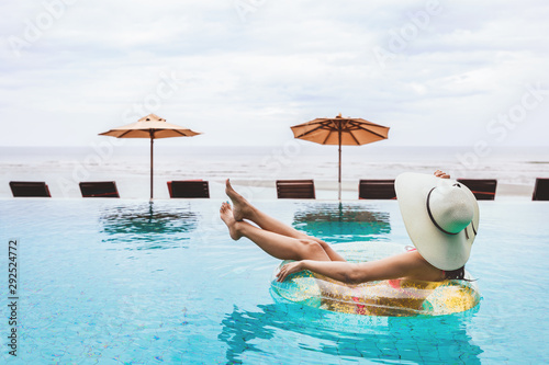 Bikini woman relaxation on pool float © Peera