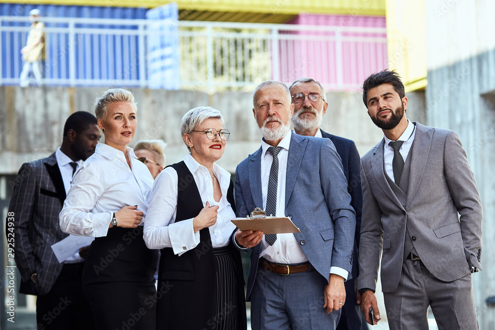 Group of businessmen wear stylish suits walking down the street. Group of businessmen wear stylish suits walking down the street.