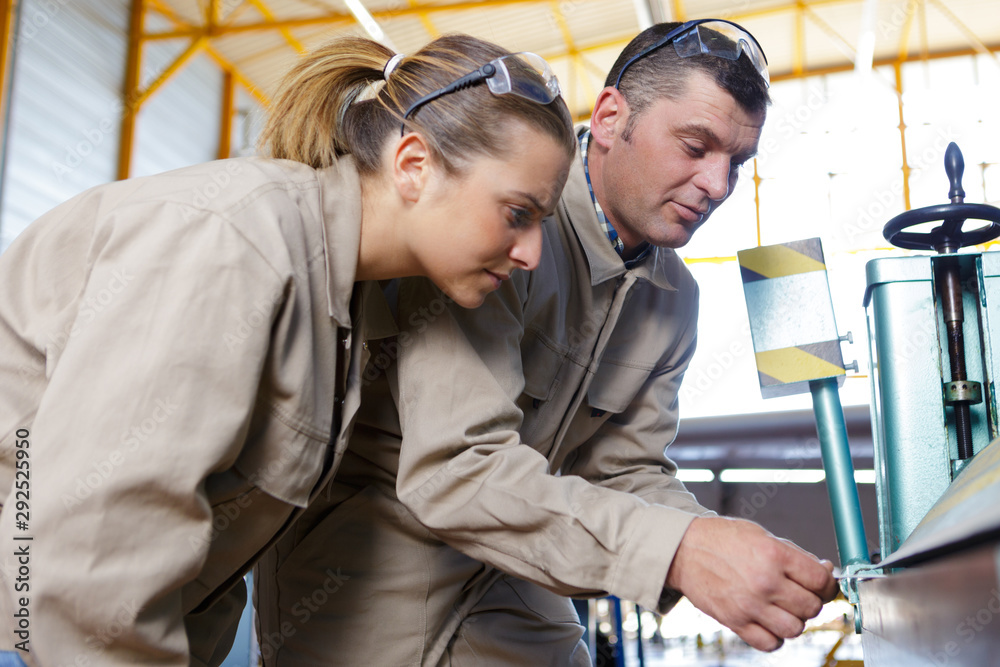workers looking at something in hangar workers looking at something in hangar