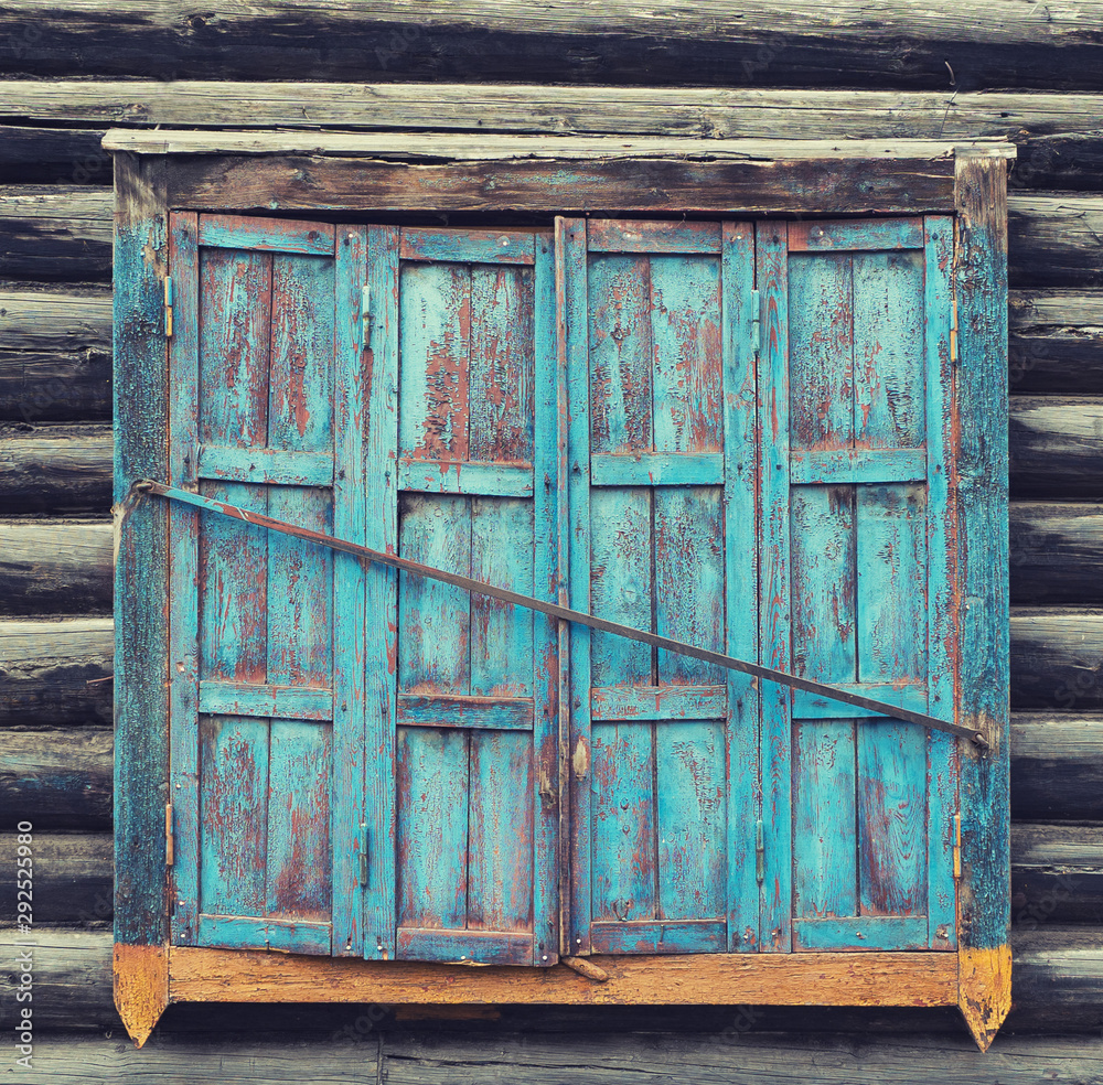 window with shutters in an old wooden house, historic building window with shutters in an old wooden house, historic building