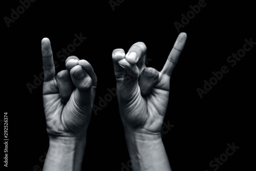 Pair of male teenager's hand doing Mahasirs Mudra isolated on a black background which reduces headache, stress and tension. photo