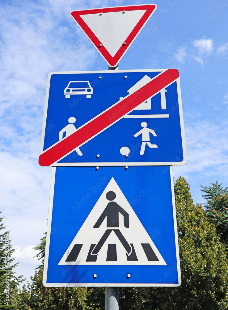 Yield and pedestrian traffic signs next to the road Stock Photo Adobe Stock