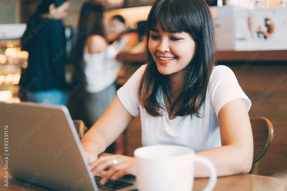 young woman with laptop in cafe young woman with laptop in cafe