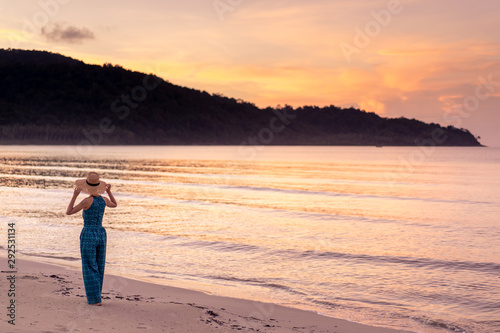 woman relaxing on the beach with sunset in koh kood island