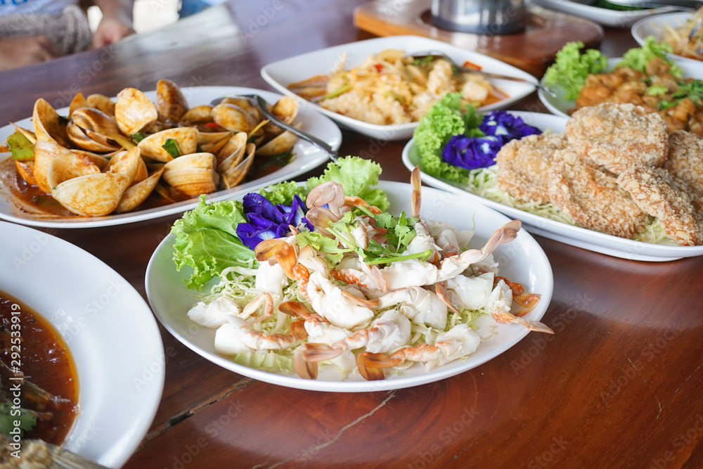 Seafood dishes. A lot of seafood dishes with soft focus on the steamed crab.