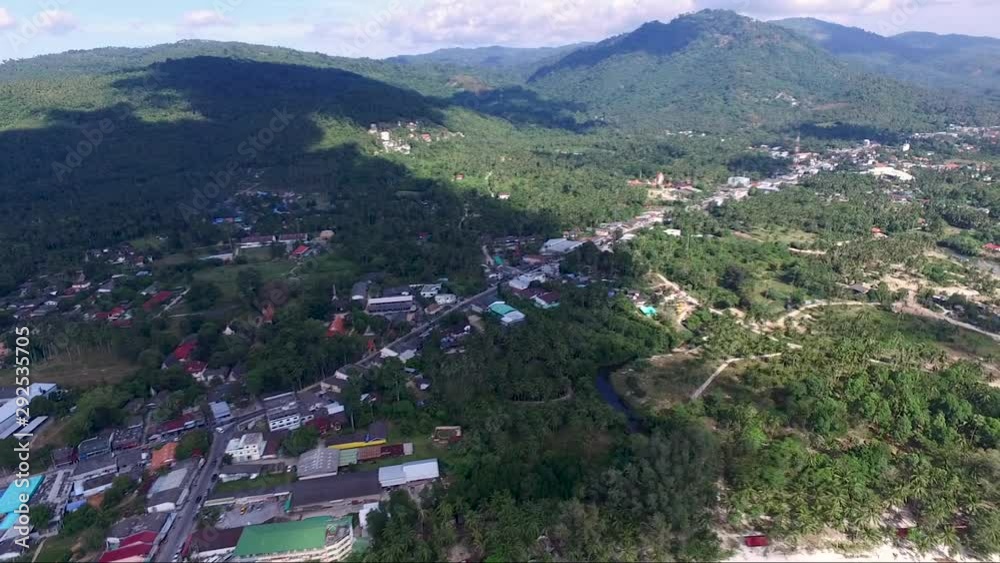 Panning aerial shot of a landscape of Koh Samui island: forest, hills and a town in Thailand. Panning aerial shot of a landscape of Koh Samui island: forest, hills and a town in Thailand.