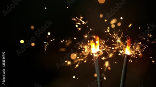 Super slow motion of burning sparklers on black background. Filmed on high speed cinema camera, 1000fps. photo