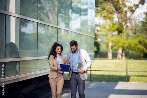 Businesswoman and businessman chatting after work