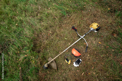 Tools and equipment for mowing grass, the lawn lies on the ground, a grass trimmer. Mowing lawns, roadsides, mowing grass.