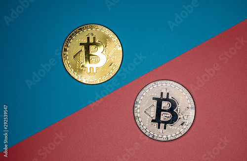 Bitcoin coins on a two-color background as the main symbol of the cryptocurrency.