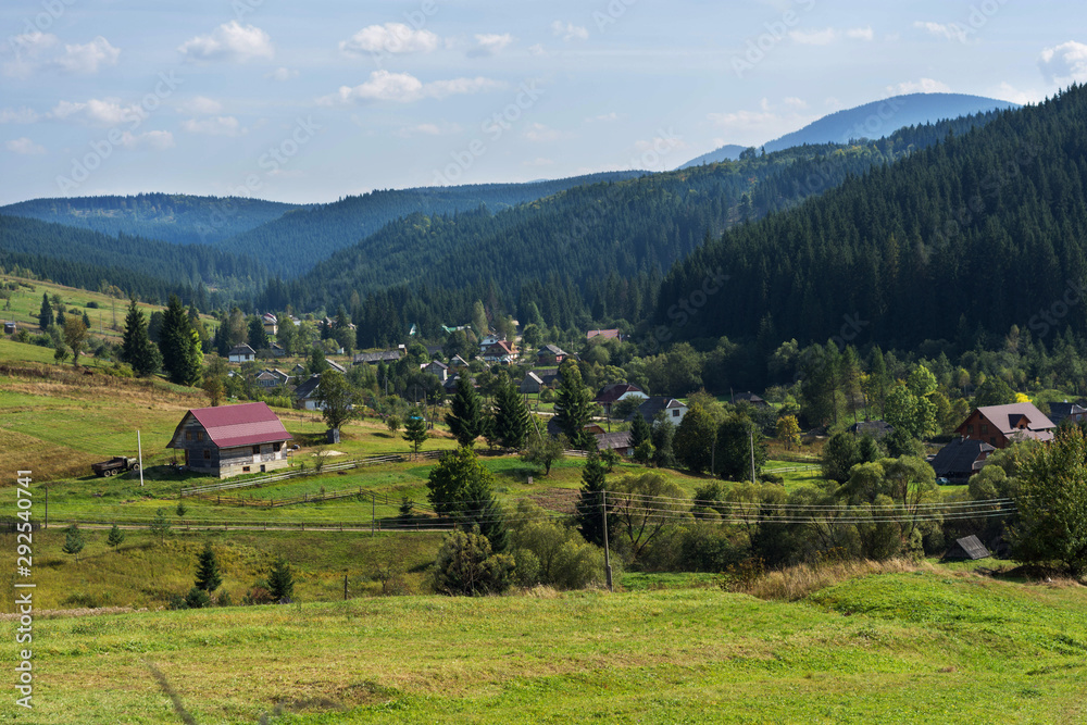 Fototapeta premium Houses Mountains in spring time. Carpathian Mountains