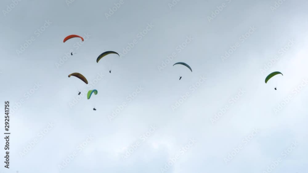 Group of Paraglider Flying and Circling in the Sky Group of Paraglider Flying and Circling in the Sky