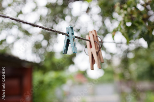 Colorful plastic clothespins on the hangers with blurred background