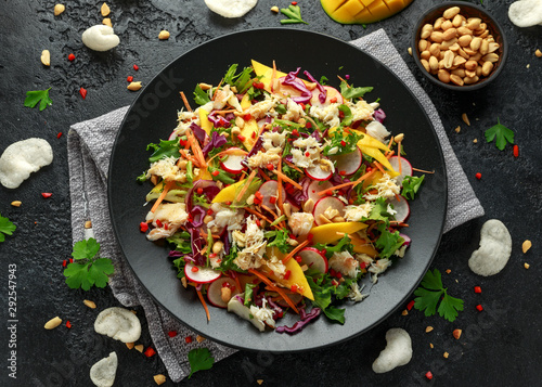 Crab salad with vegetables, radish, carrots, mango, pine nuts and prawn crackers