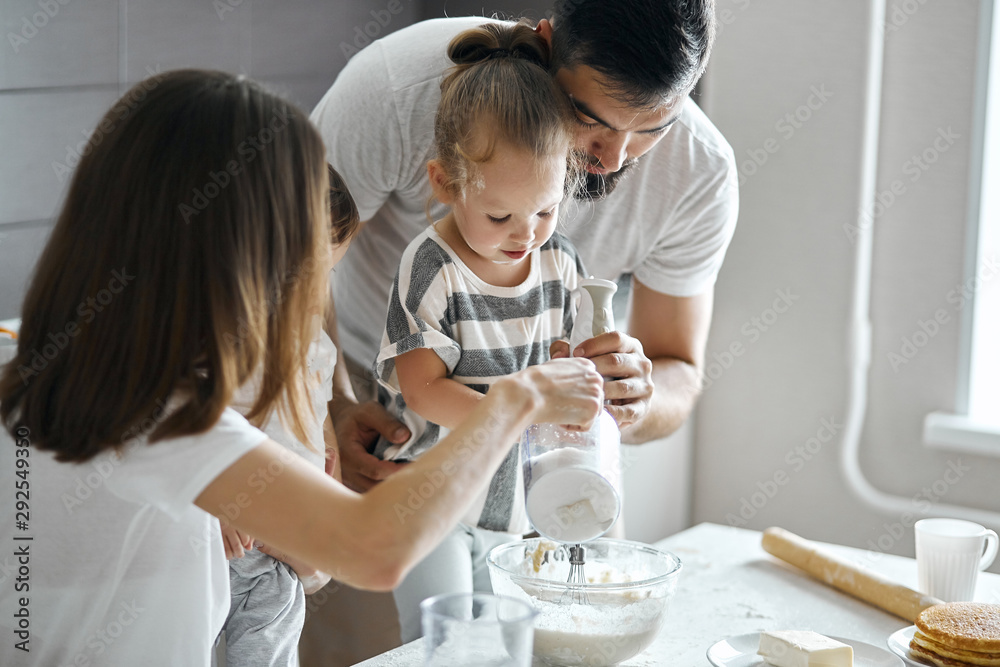 little child making dough with parents, preparing for holiday. close up cropped photo little child making dough with parents, preparing for holiday. close up cropped photo