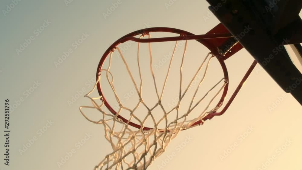Basketball ball hits into hoop outdoors close-up. successful throw of ball in basketball basket. Basketball ball hits into hoop outdoors close-up. successful throw of ball in basketball basket.