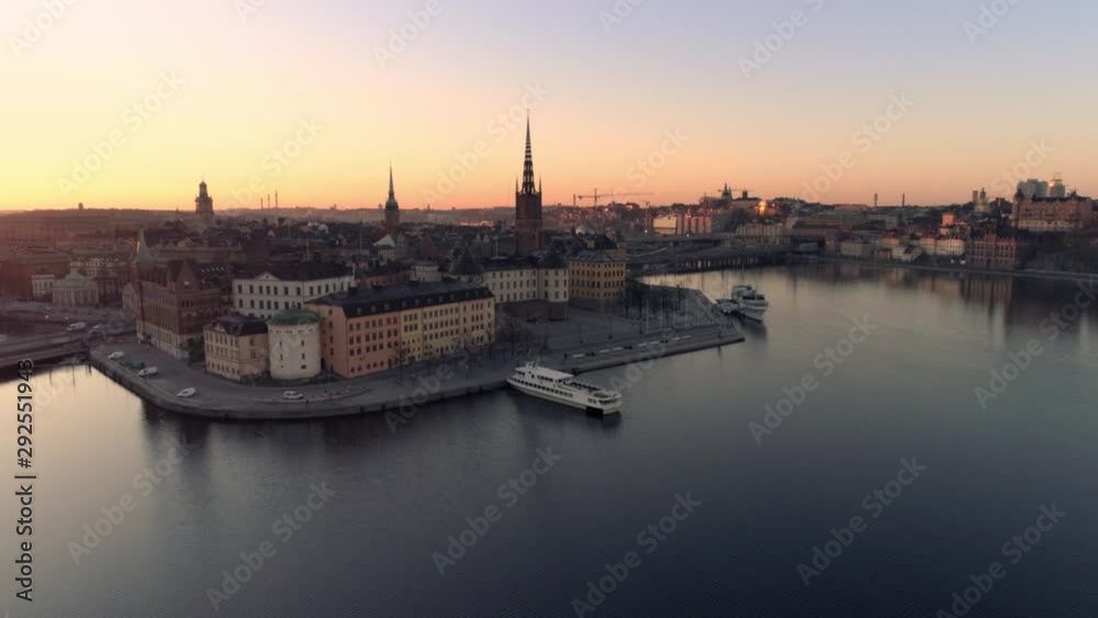 Aerial view of Stockholm skyline cityscape at sunrise. Drone shot flying over water, Riddarholmen island city buildings and church. Gamla stan, Old Town landmark, Capital of Sweden