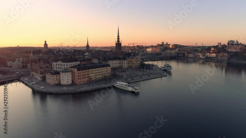 Aerial view of Stockholm skyline cityscape at sunrise. Drone shot flying over water, Riddarholmen island city buildings and church. Gamla stan, Old Town landmark, Capital of Sweden