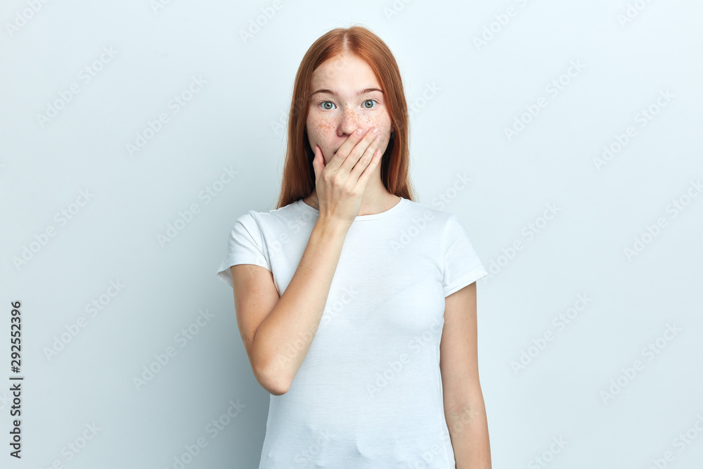 Close up portrait of upset scared hipster girl , covering her mouth with palm to prevent screaming sound, after seeing or hearing something bad. Negative emotions Close up portrait of upset scared hipster girl , covering her mouth with palm to prevent screaming sound, after seeing or hearing something bad. Negative emotions