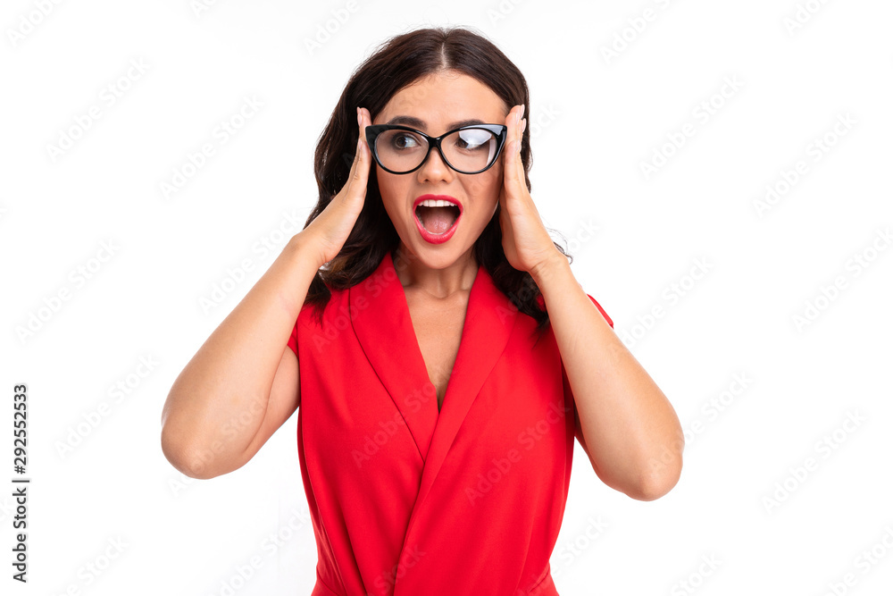 Beautiful middle-aged brunette looking at the camera. Holds his hands behind his head. Glasses for sight Beautiful middle-aged brunette looking at the camera. Holds his hands behind his head. Glasses for sight