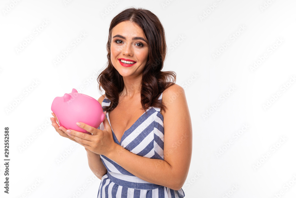 girl on a white background with a piggy bank in hands girl on a white background with a piggy bank in hands