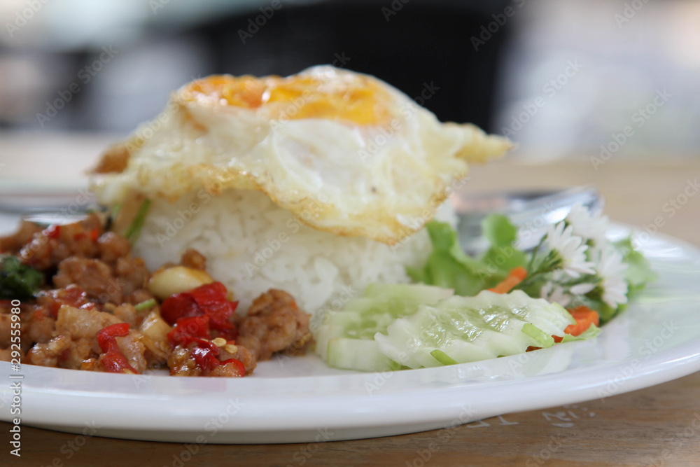 Thai food, stir-fried pork with basil and fried egg on rice Thai food, stir-fried pork with basil and fried egg on rice