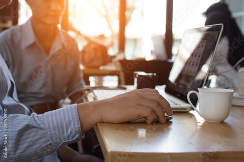 businessman typing with laptop.working at coffee shop.Prepare a proposal to the Special Project Director.