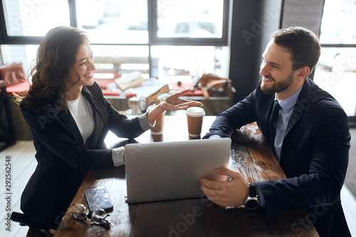 cunning beautiful woman persuading handsome bearded man to cooperate with her company. close up photo photo