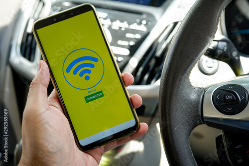 A man hand holding smartphone with  wifi searching on the screen. Wi-fi is the current generation Wi-fi connectivity with high capacity, coverage and performance.