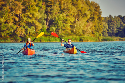 People kayak during sunset in the background. Have fun in your free time. #292565904