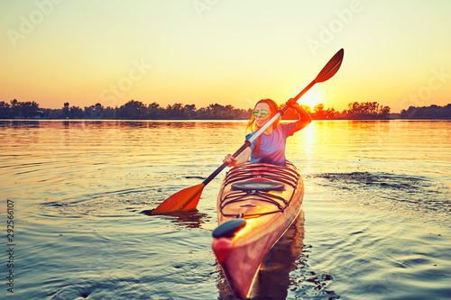 People kayak during sunset in the background. Have fun in your free time. #292566107
