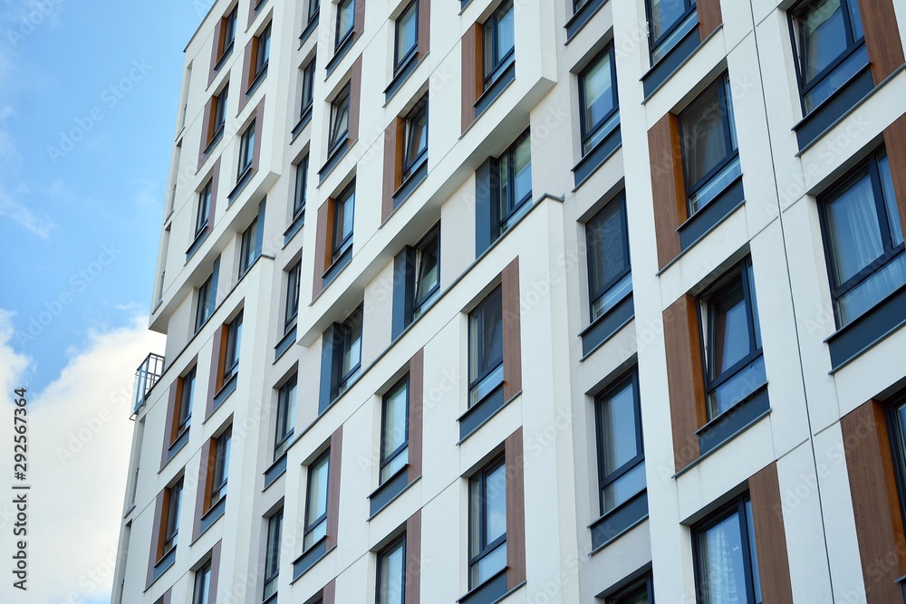 Modern luxury urban apartment building exterior with blue sky Modern luxury urban apartment building exterior with blue sky
