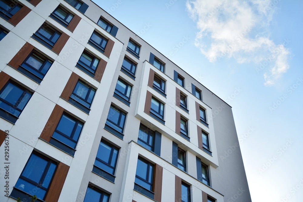 Modern luxury urban apartment building exterior with blue sky Modern luxury urban apartment building exterior with blue sky