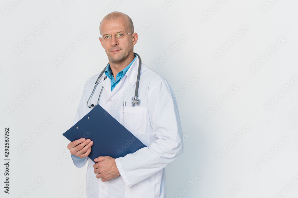 Young successful bald practitioner in whitecoat holding document Young successful bald practitioner in whitecoat holding document